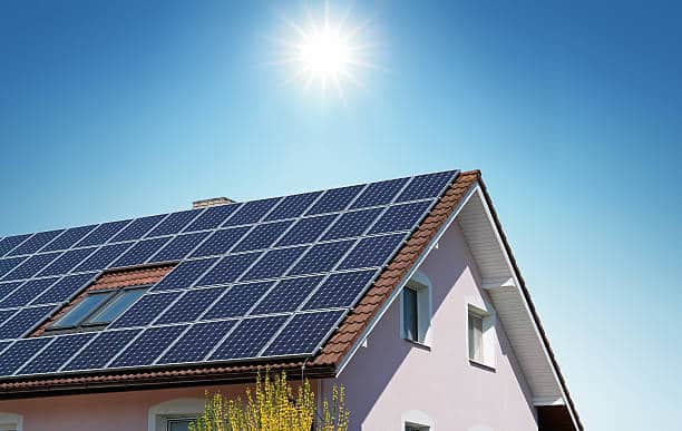 House with Photovoltaics Panels on the Roof Getting Energy from the Sunlight